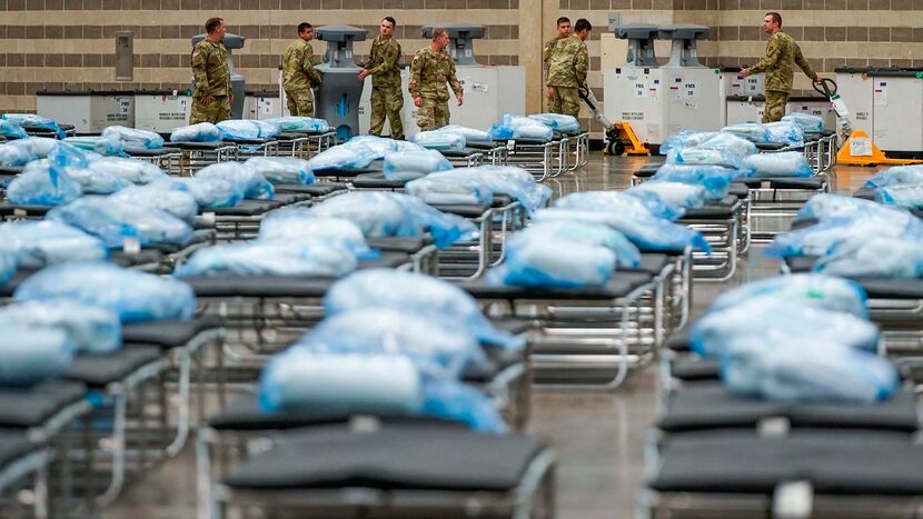 Members of the Texas Army National Guard unpacked crates of supplies as they set up a field...