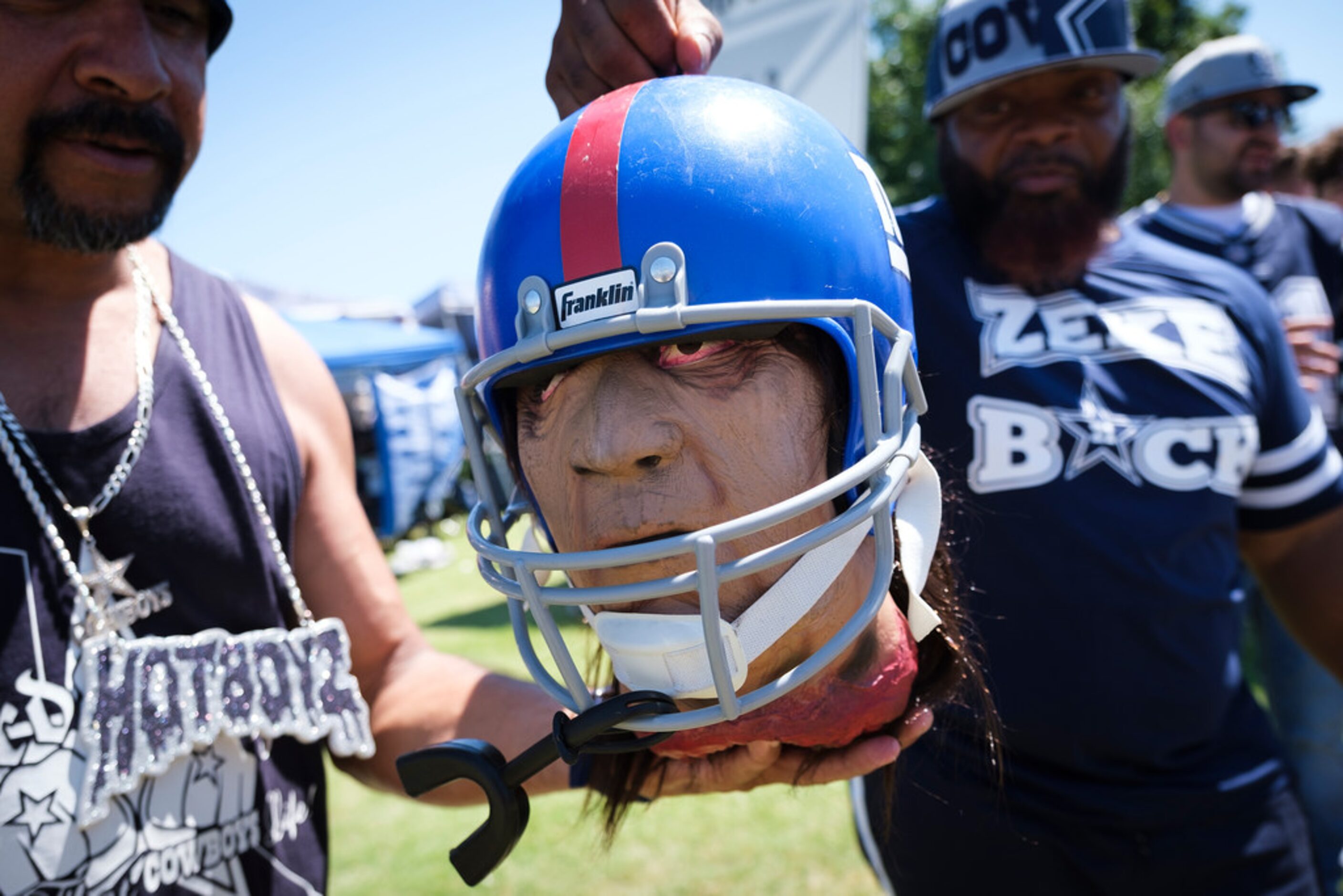 Fans display a mock beheaded New York Giants helmet as they tailgate before an NFL football...