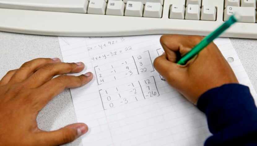 
Janani Ramachandran, a senior at Plano Senior High School, works on a math equation while...