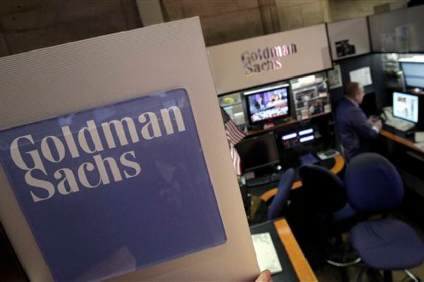  In this March 15, 2012, photo, a trader works in the Goldman Sachs booth on the floor of...