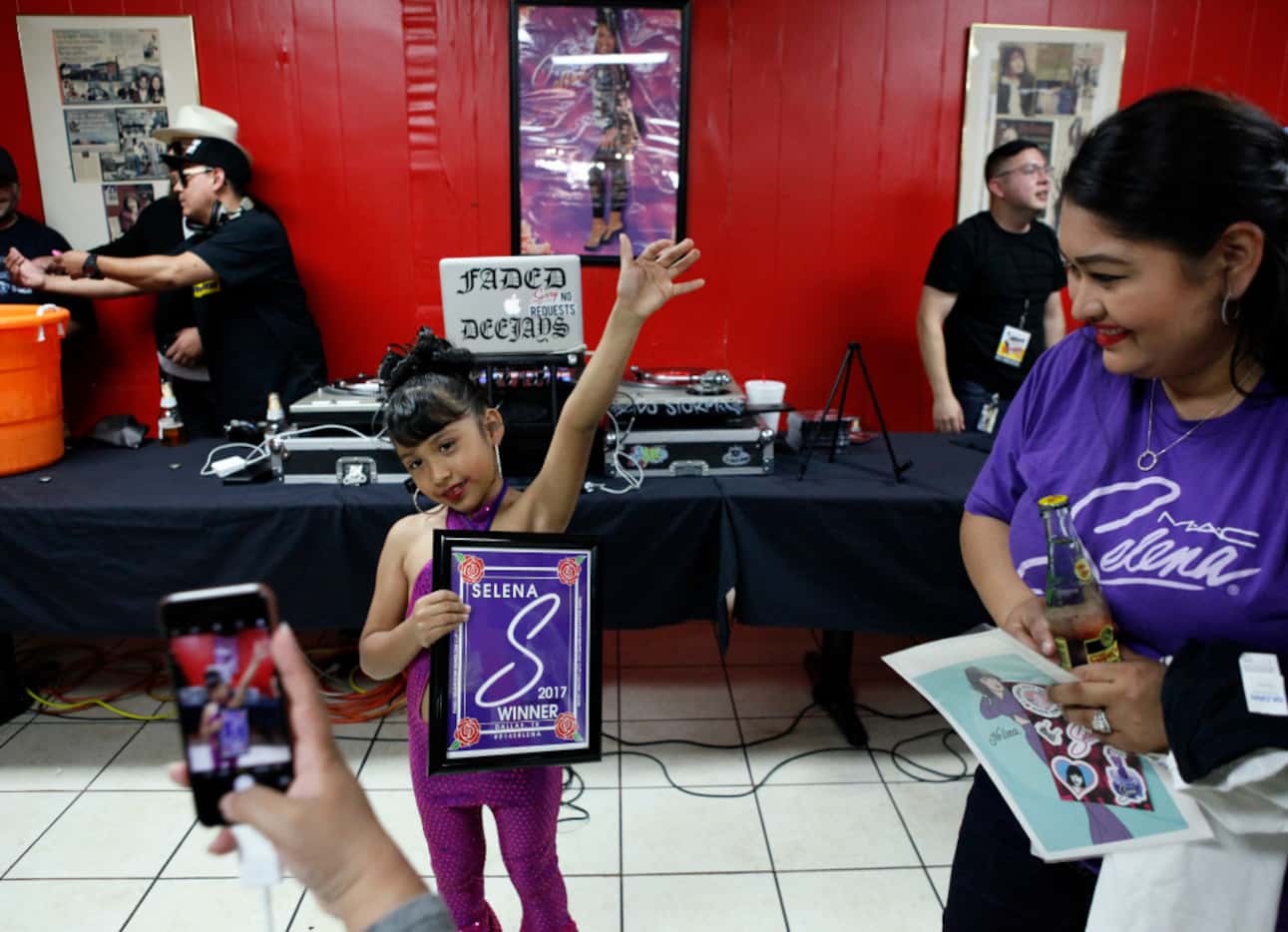 Monique Garcia (right) watches her daughter, Azlie Garcia, 6, raise her arm in victory after...