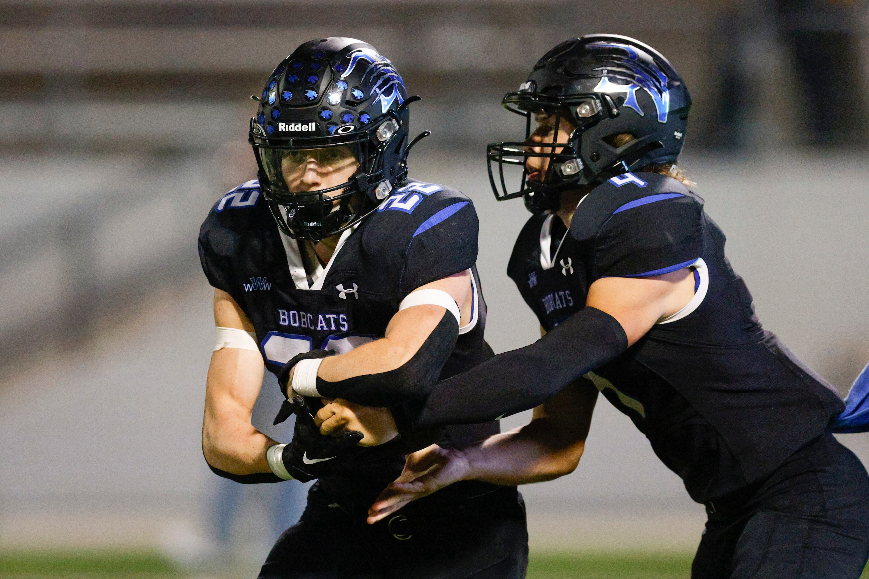 Trophy Club Byron Nelson quarterback Grant Bizjck (4) hands the ball to running back Blayne...