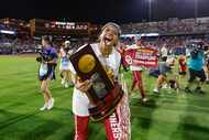 Oklahoma outfielder Rylie Boon holds the trophy after Oklahoma defeated Texas in the NCAA...