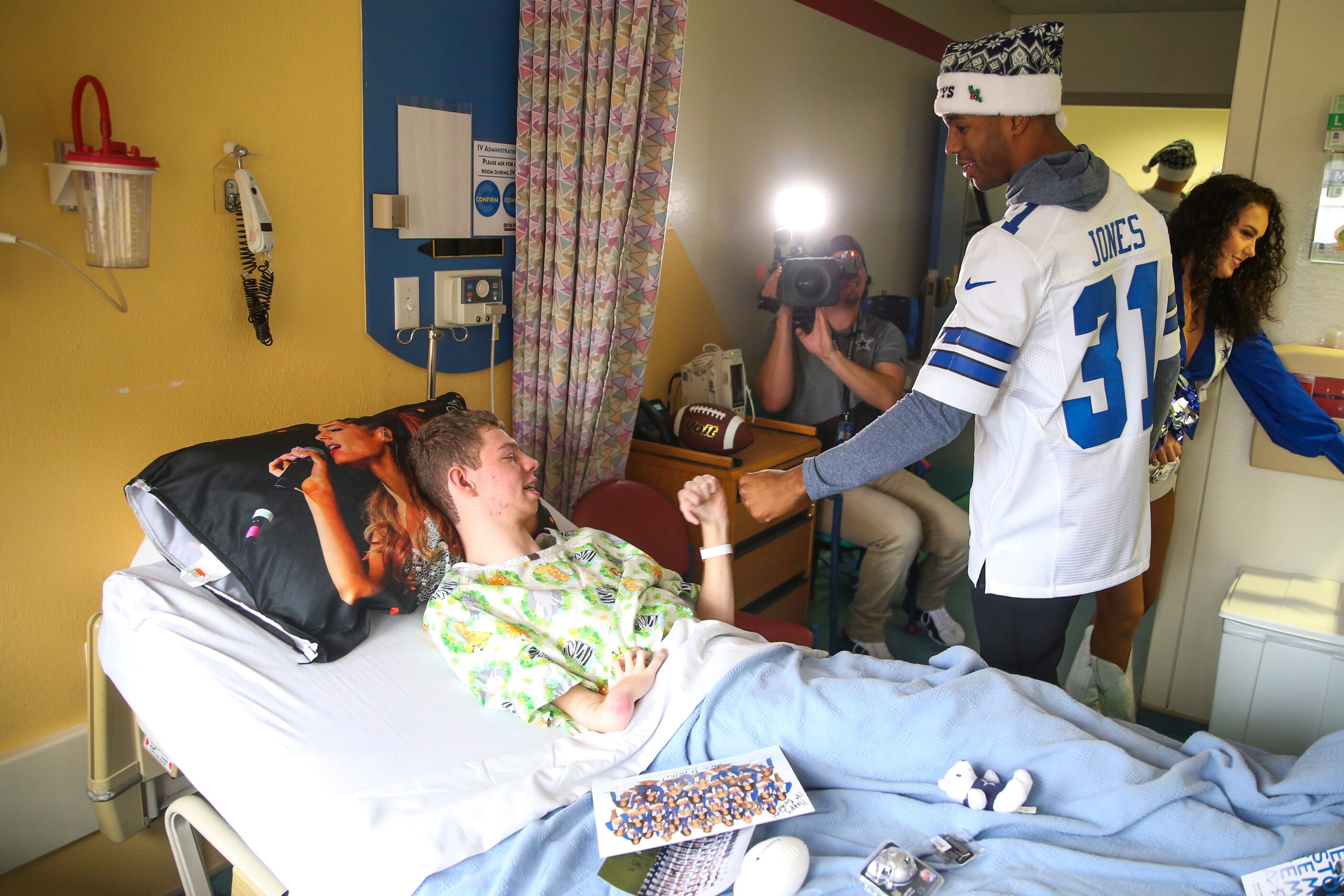 Austin Shay, 18, fist bumps Dallas Cowboys cornerback Byron Jones (31) as he makes his way...