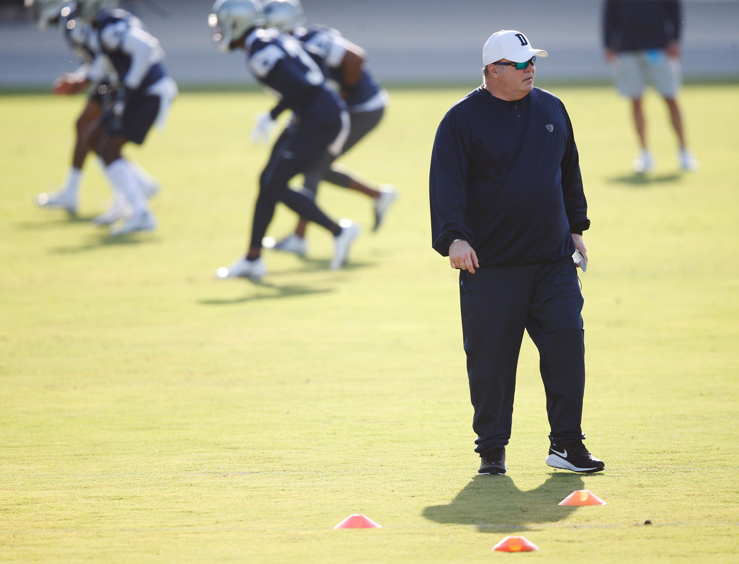 Dallas Cowboys head coach Mike McCarthy watches practice on the first day of training camp...