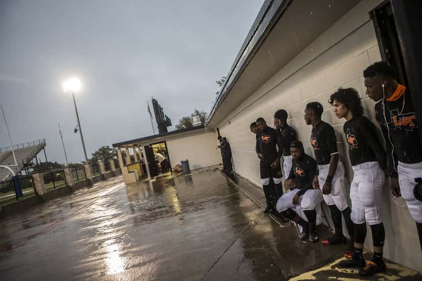 The Tigers watch the rain pour down during a lightning delay before Lancaster's matchup...