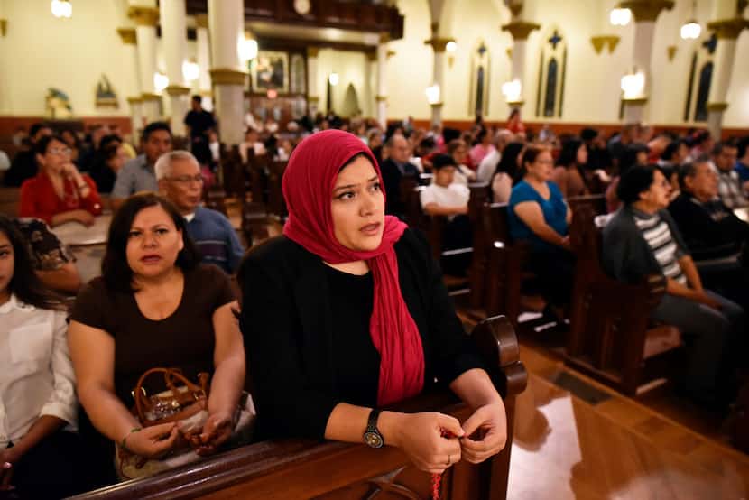 Lisette Moreno prays the rosary with her mother, Guadalupe Niño (left), at the Cathedral...