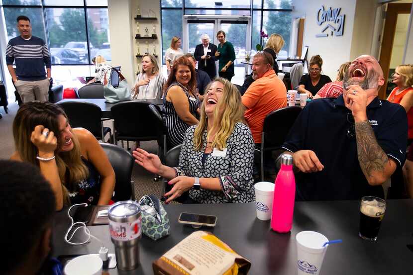 LeAnne Burnett (center) laughs with Michael Padgett and Michele Creech during a  happy hour...