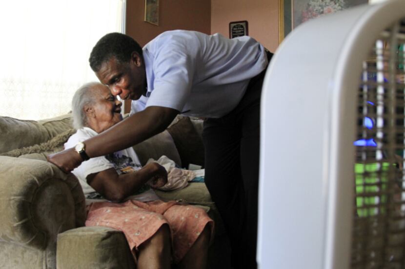 Zachary S. Thompson, director of Dallas County Health and Human Services, gives 101-year-old...