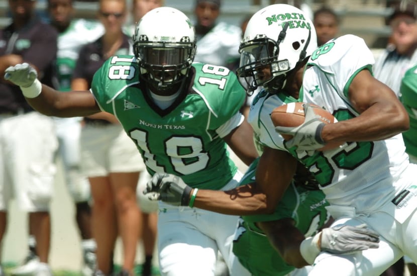 White team Wide reciever Jamize Olawale (83) shakes off a hit by Green linebacker Will...