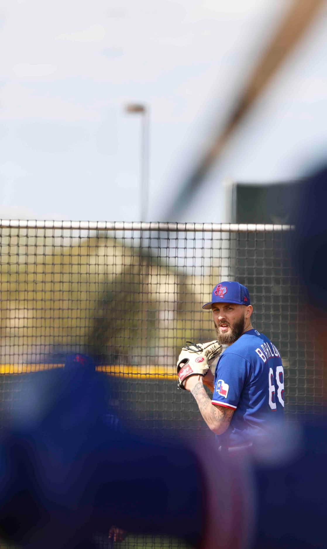 Texas Rangers pitcher Joe Barlow gets set to throw a pitch during a spring training workout...