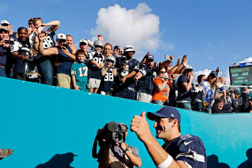 Dallas Cowboys quarterback Tony Romo gives a thumbs up to fans following Dallas' 24-14 win...