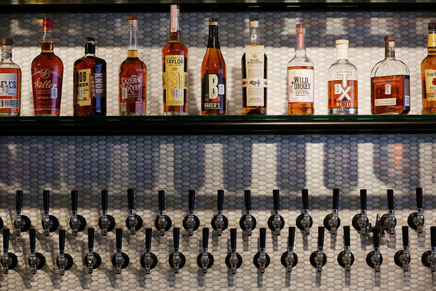 The bar inside Local Traveler has an extensive whiskey collection, plus 40 taps for beer,...