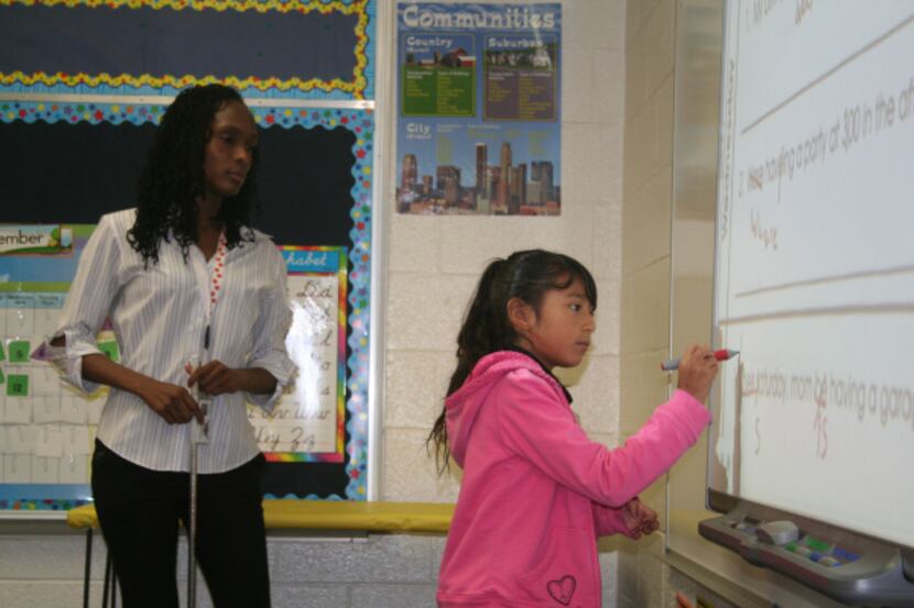 Bray Elementary teacher Bridgett Smith works with third-grader Damaris Alvarado on a grammar...