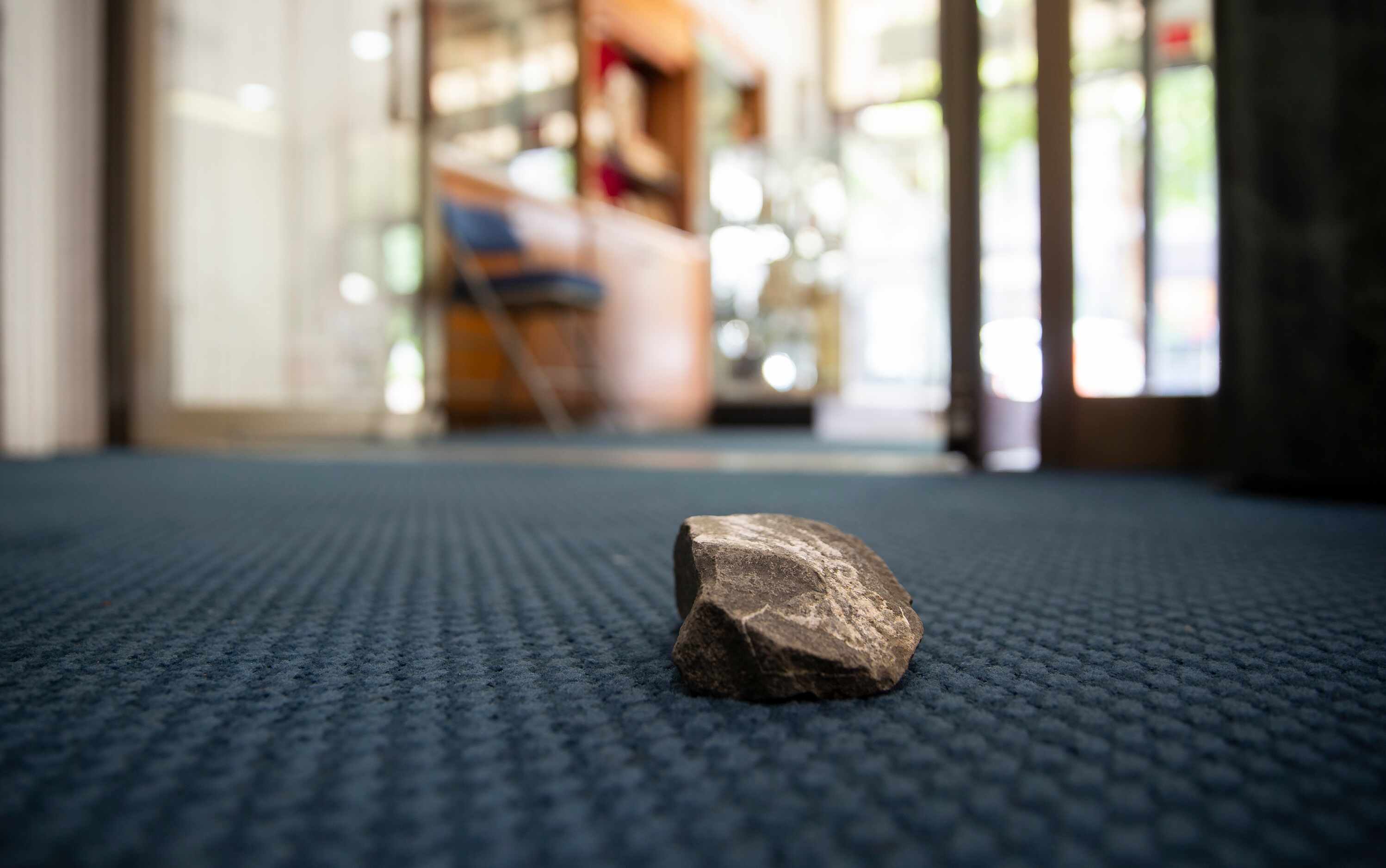 A rock that was thrown through a window at St. Jude Chapel remains Saturday morning, May 30,...