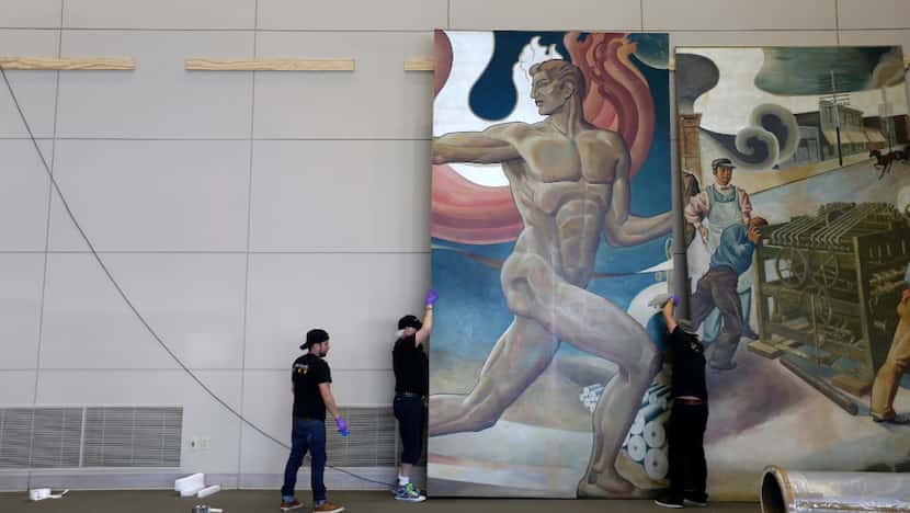 Workers from Unified Fine Arts remove the murals from the TXCN building at the former Dallas...