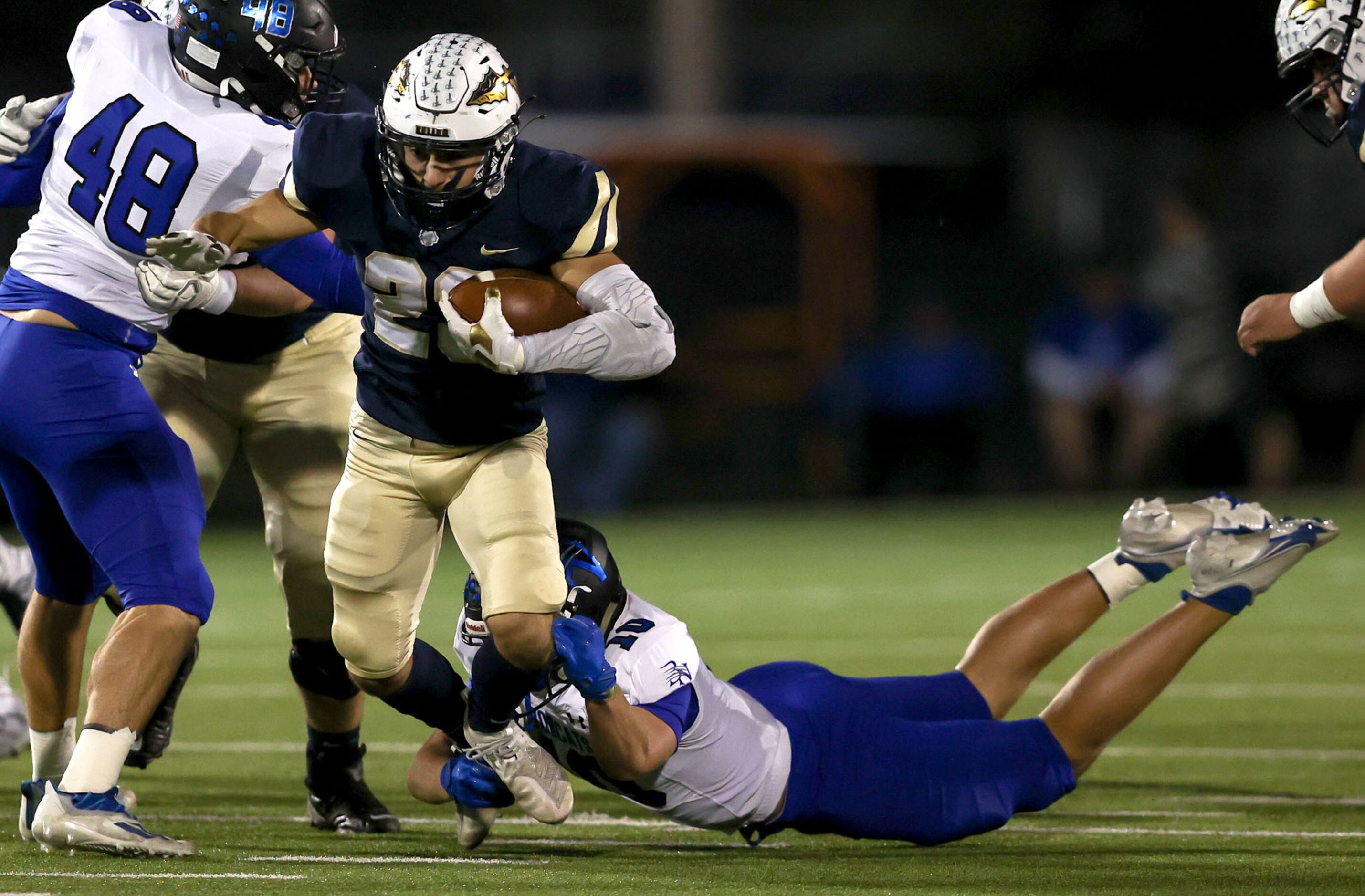 Keller running back Jackson Kraatz (23) tries to avoid be stopped by Byron Nelson linebacker...