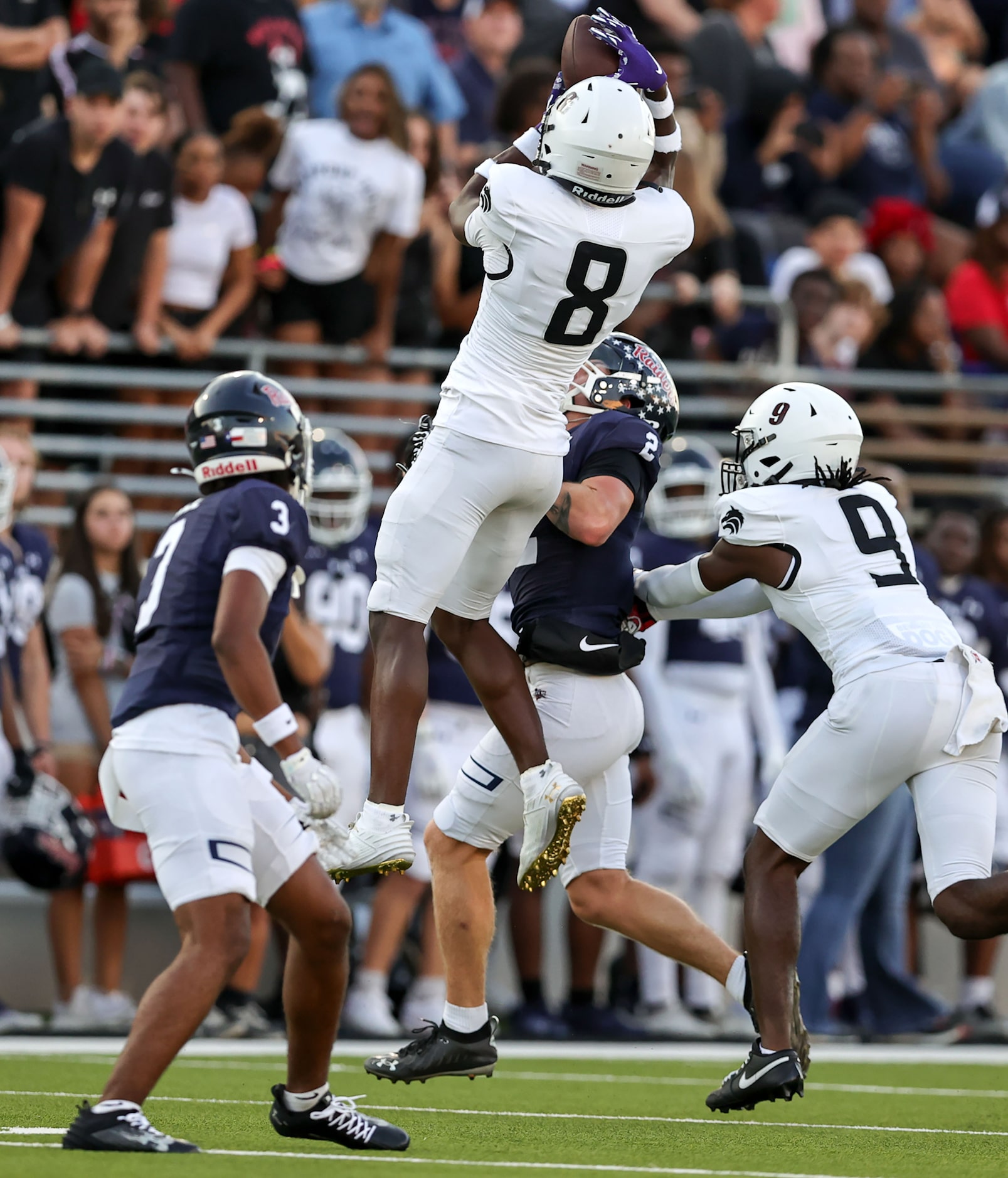 Mansfield Timberview safety Chance Collins (8) comes up with an interception against Denton...