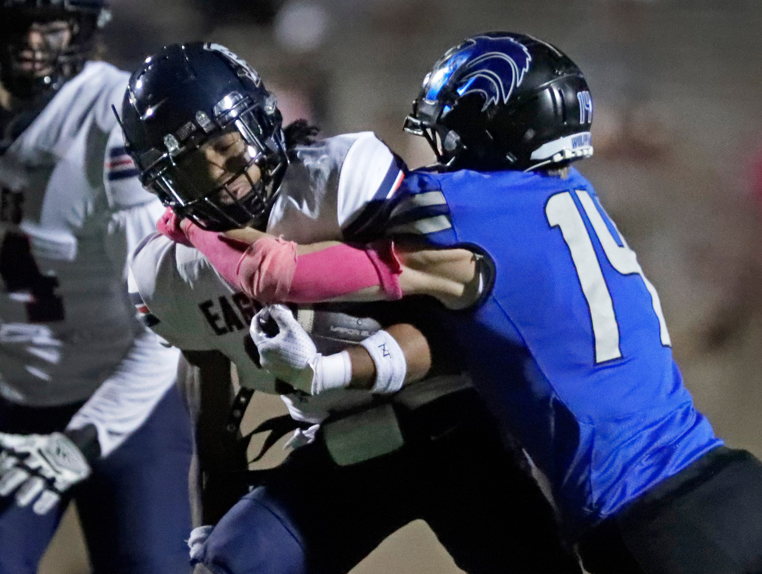 Allen High School running back Micah Ellis (2) is tackled by Plano West High School...