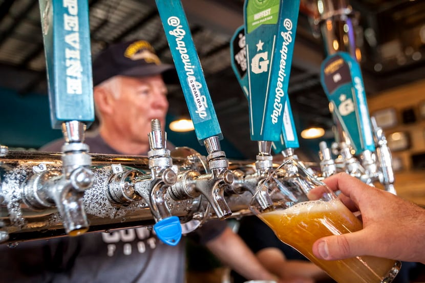 A light beer is drawn from the tap at the Grapevine Craft Brewery. In 2013, Texas laws...