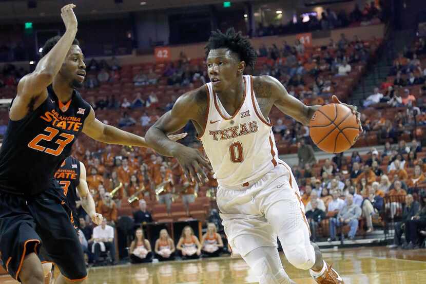 AUSTIN, TX - JANUARY 4: Tevin Mack #0 of the Texas Longhorns drives around Leyton Hammonds...