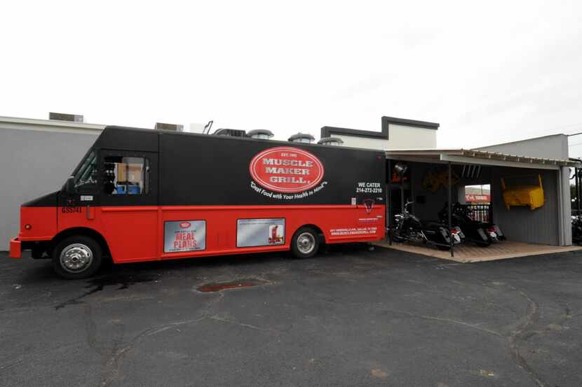 Food trucks like Muscle Maker Grill sit in the parking lot for hungry guests at Mother...