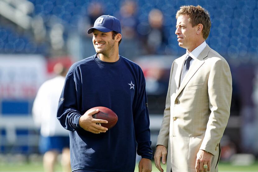 Dallas Cowboys quarterback Tony Romo (left) talks with Fox sports announcer Troy Aikman...