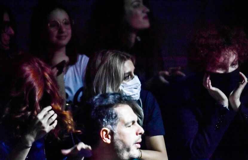 A guest wearing a face mask waits for the start of the Dolce & Gabbana's women fall/winter...