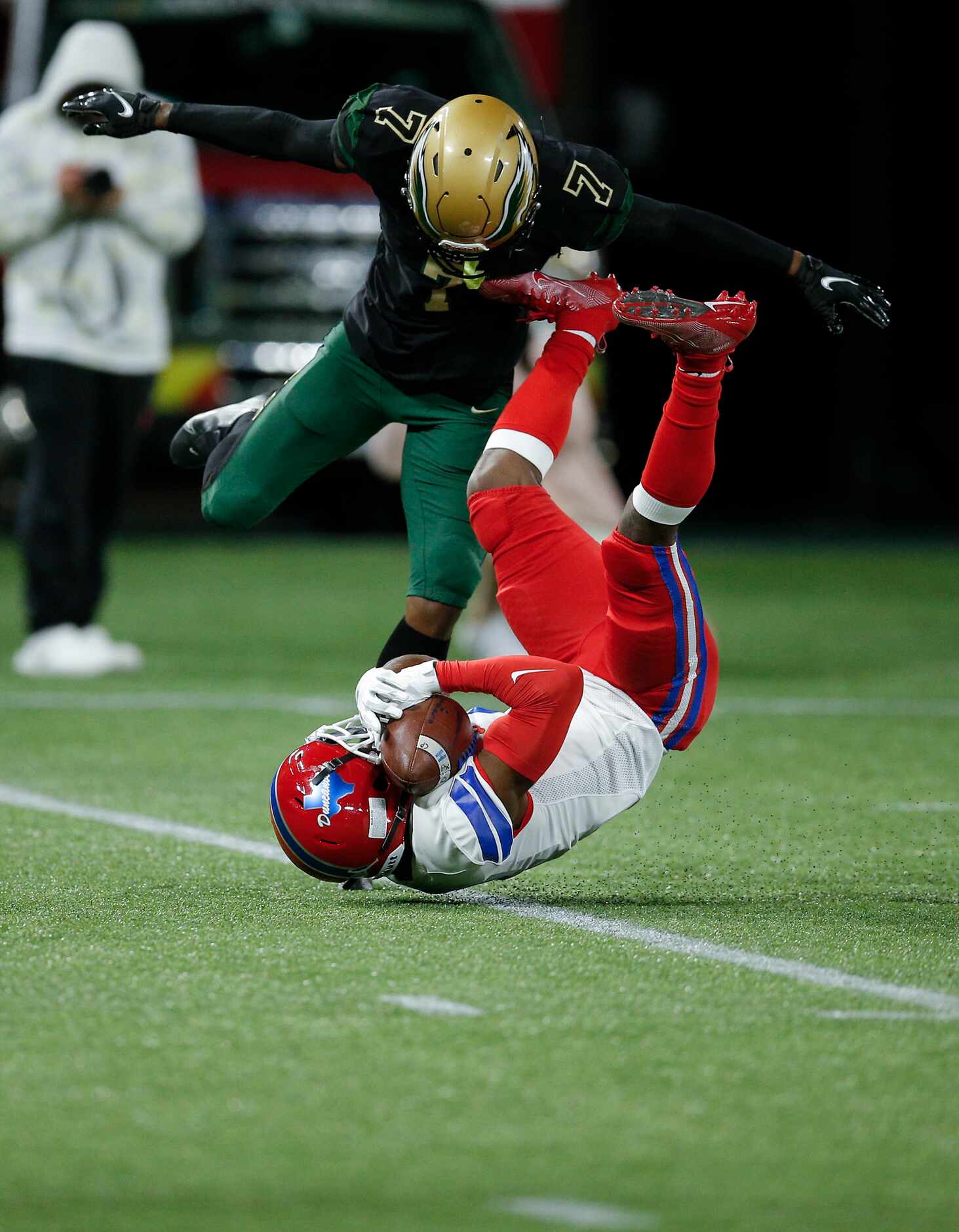 Duncanville junior running back Chris Hicks (1) catches a pass as DeSoto senior cornerback...