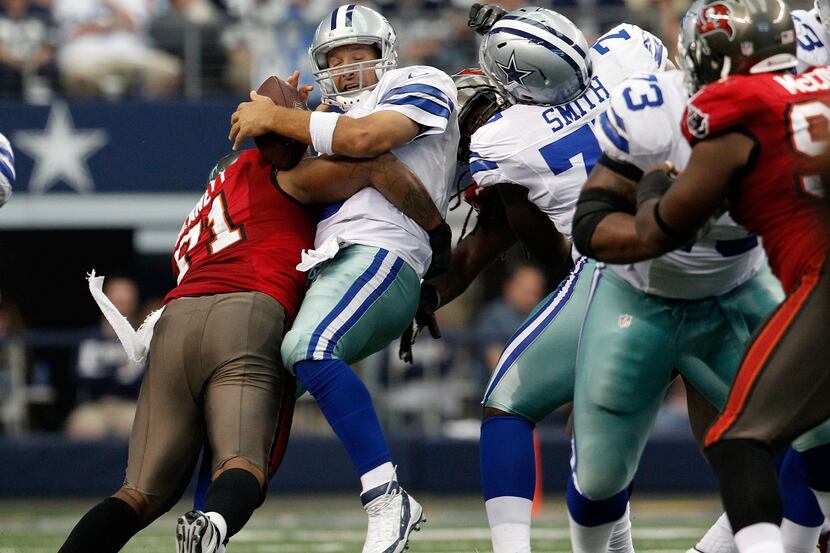 ARLINGTON, TX - SEPTEMBER 23:  Tony Romo #9 of the Dallas Cowboys fumbles the ball after...