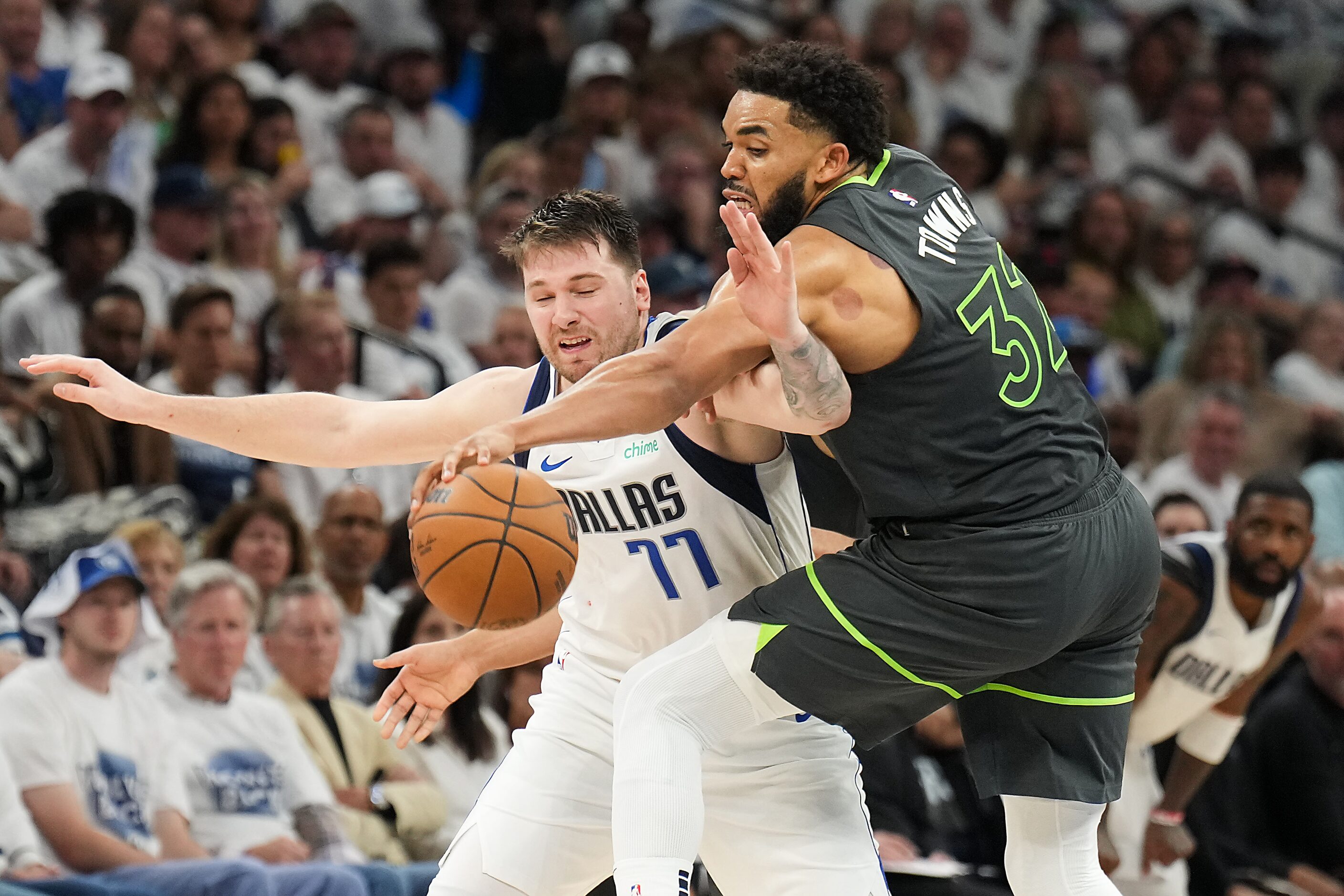 Dallas Mavericks guard Luka Doncic (77) is fouled by Minnesota Timberwolves center...