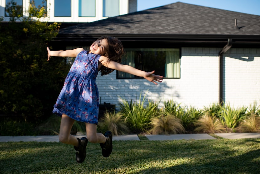 Quinn Jones, 8, leaps in the backyard of her Dallas home. “I’m back, baby!” she exclaimed....