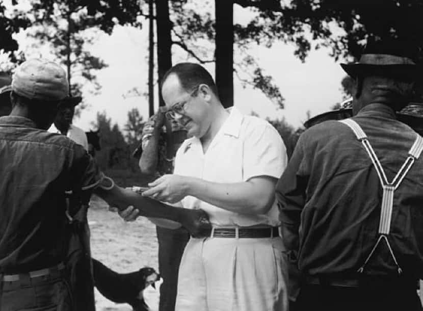 In an undated handout photo, a doctor injects a patient as part of the Tuskegee syphilis...
