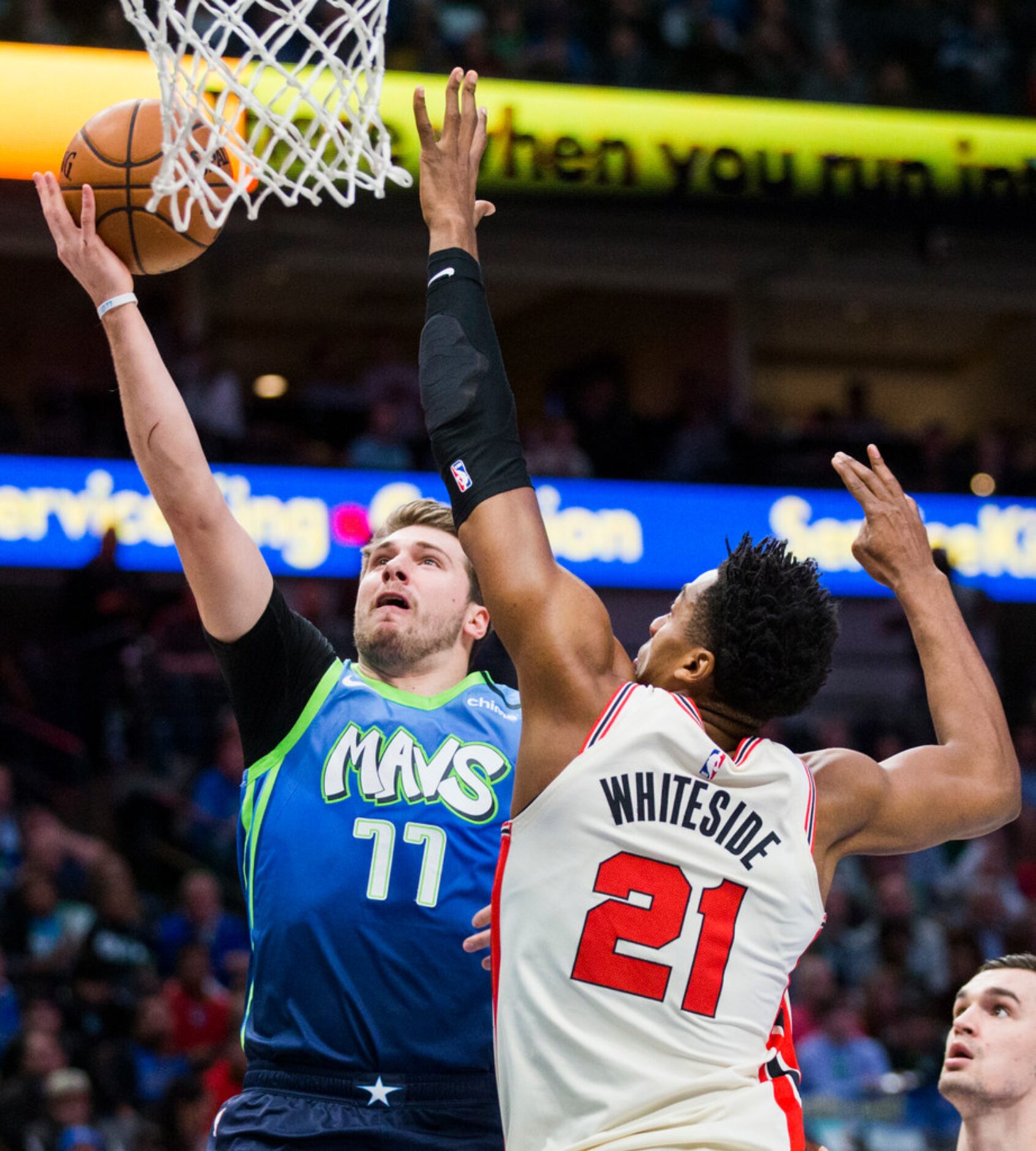 Dallas Mavericks forward Luka Doncic (77) goes up for a shot while defended by Portland...