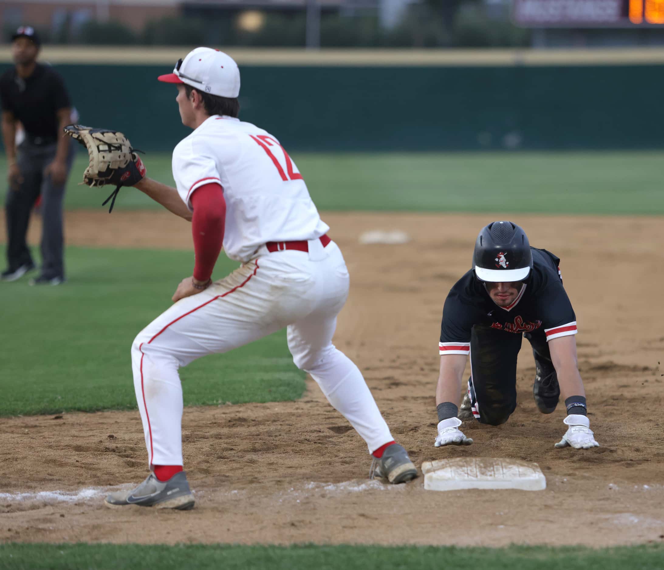 Argyle High School player Colton Roquemore slides back into first base as Grapevine High...