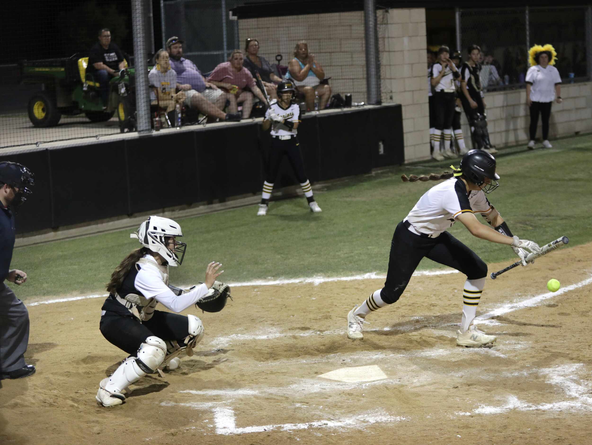 Frisco Memorial High School #13, Madelyn Muller, goes for a bunt during a softball game...