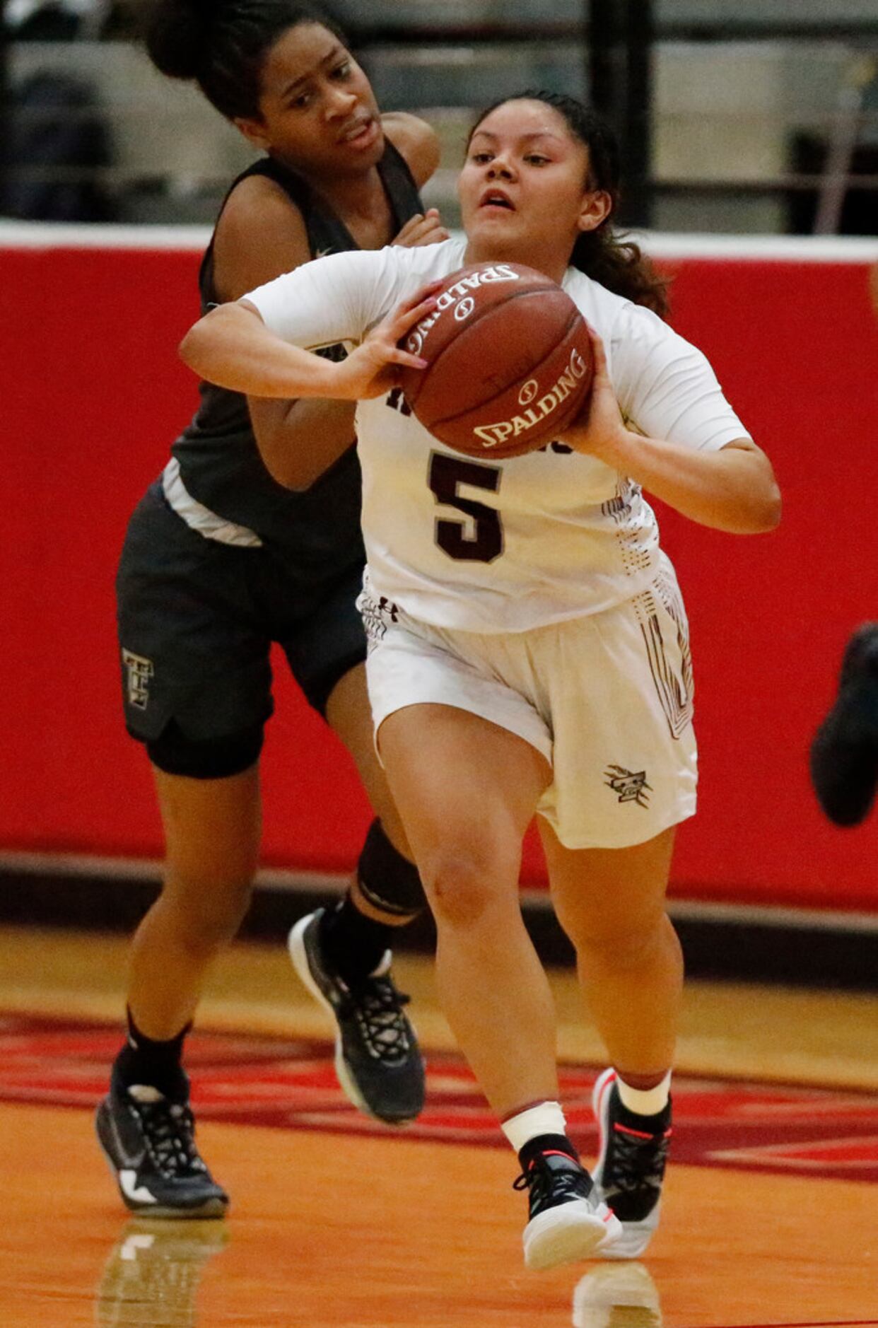 Timberview High School guard Nina Milliner (5) passes the basketball to break the press...