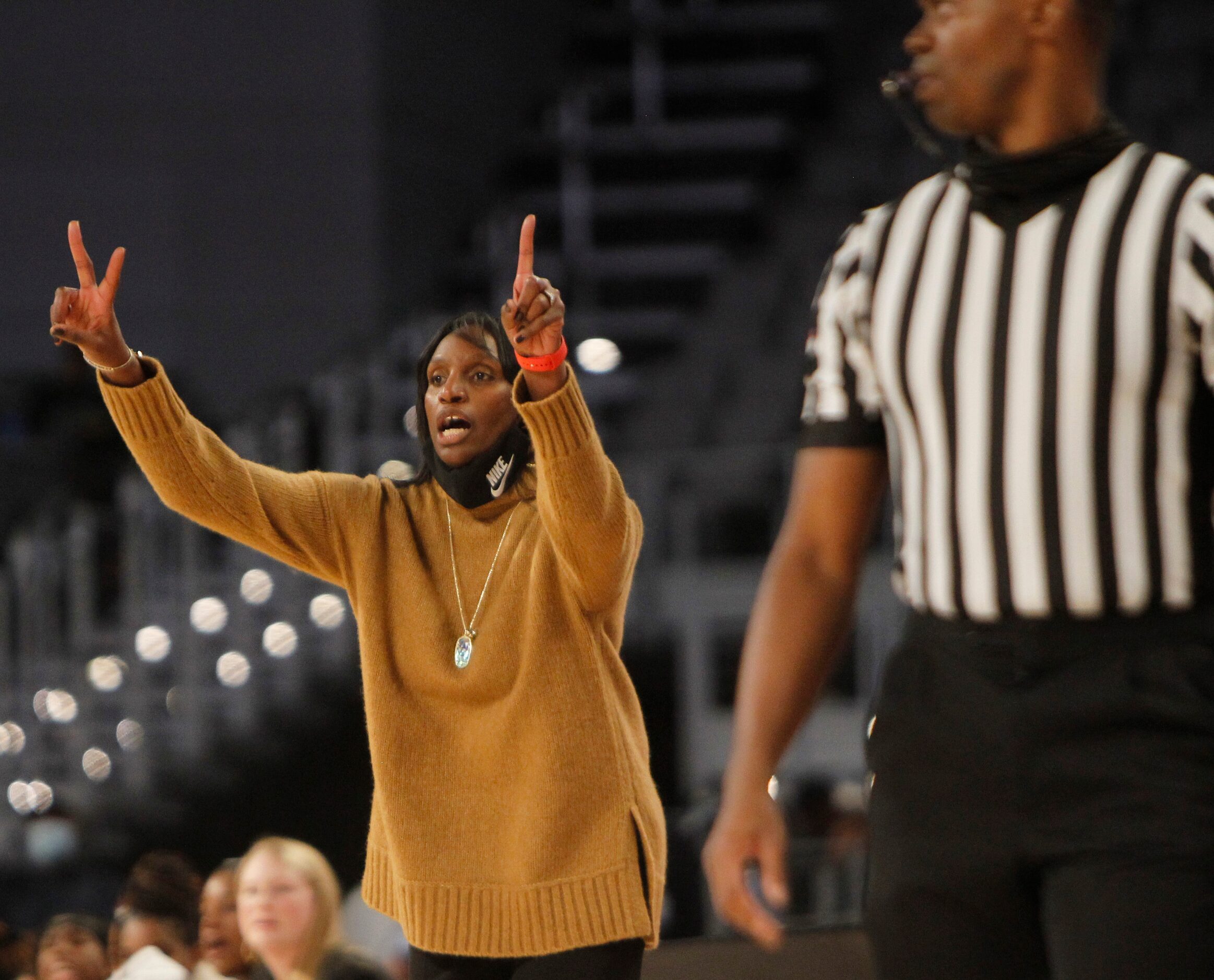 DeSoto head coach Andrea Robinson sends a play in from the team bench area during first half...