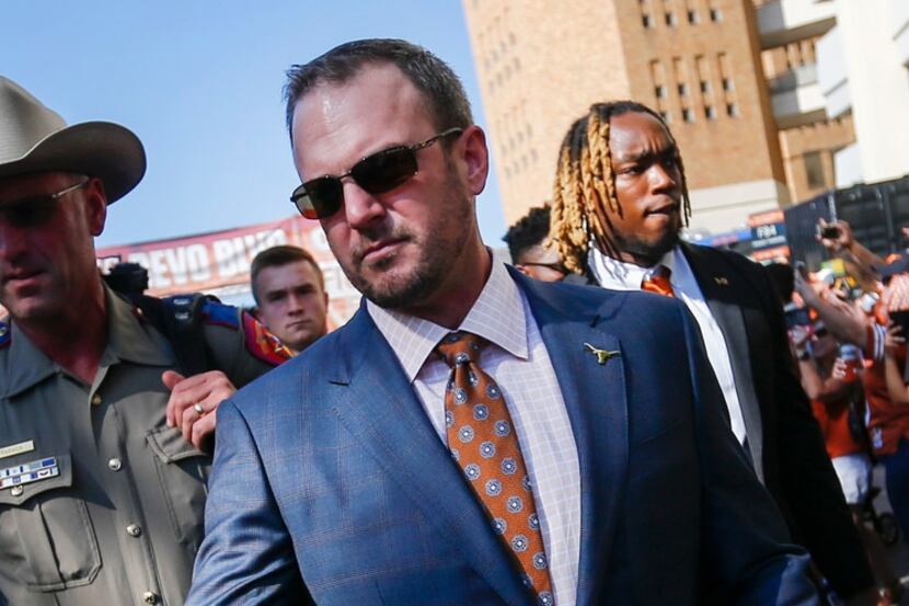 Texas Longhorns head coach Tom Herman greets fans as the team makes their way down Bevo...