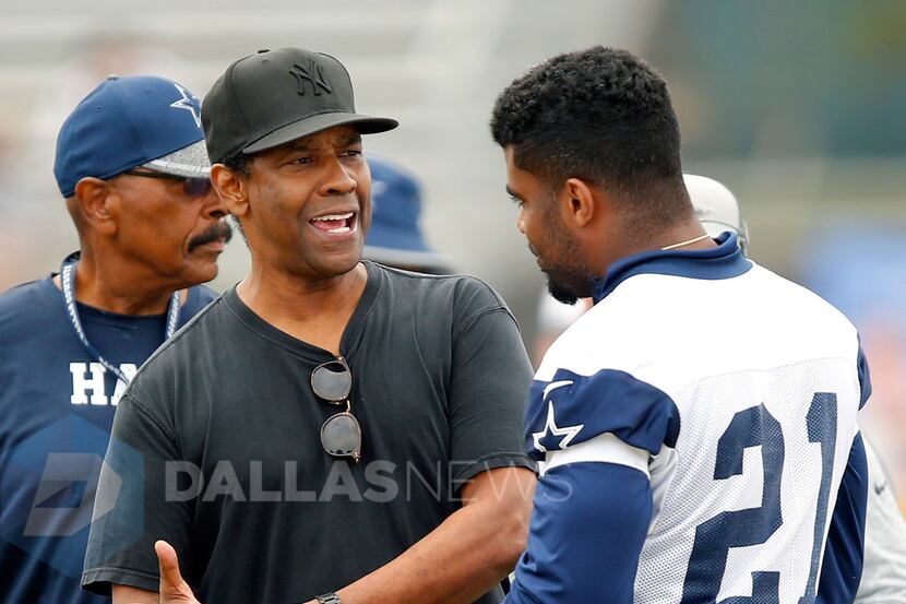 Dallas Cowboys fan and actor Denzel Washington (left) visits with Dallas Cowboys rookie...