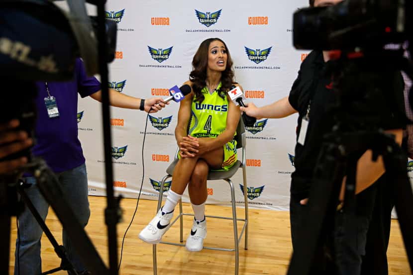 Dallas Wings guard Skylar Diggins (center) talks to reporters during a media day for the new...