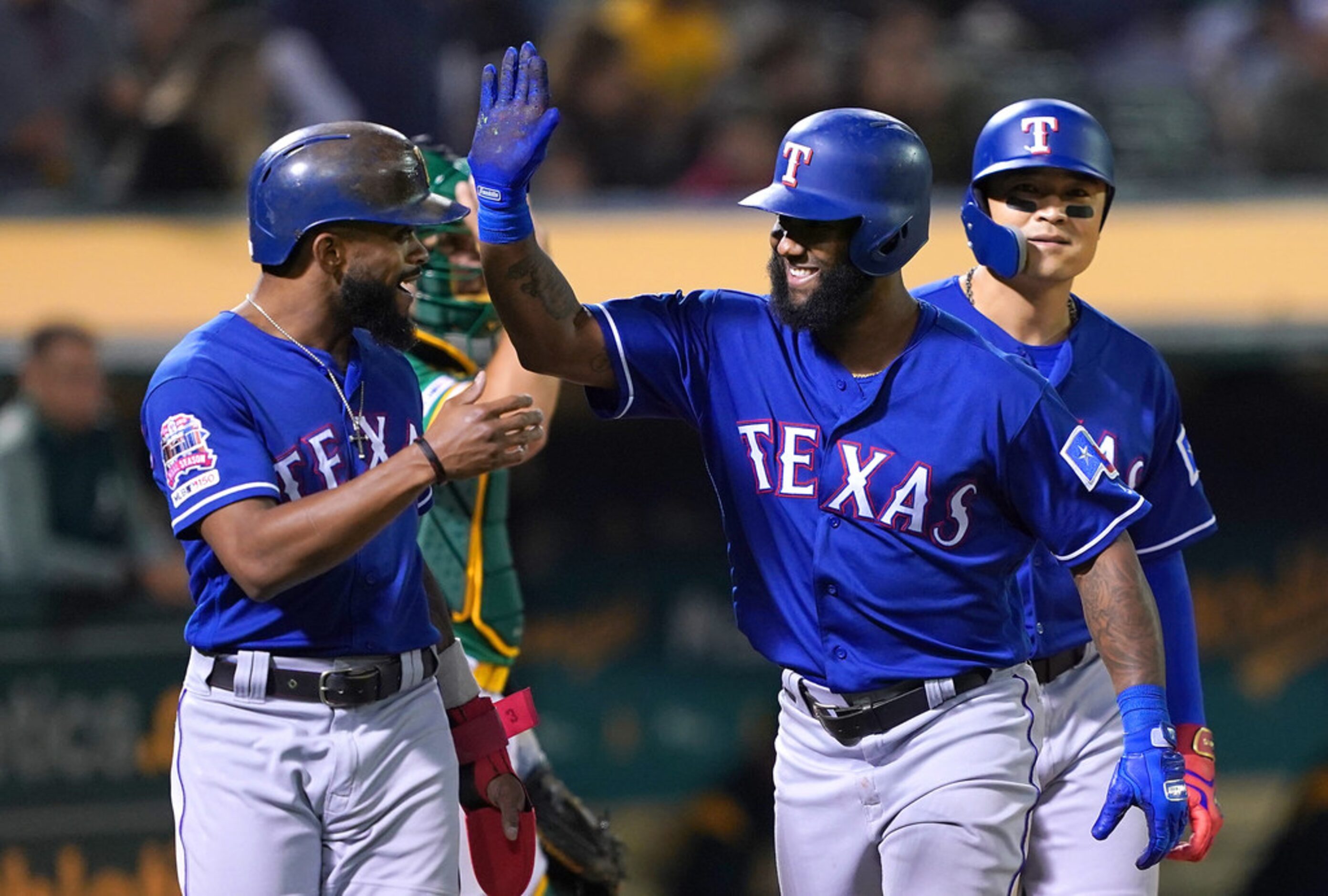 OAKLAND, CA - JULY 25:  Danny Santana #38 of the Texas Rangers is congratulated by Shin-Soo...