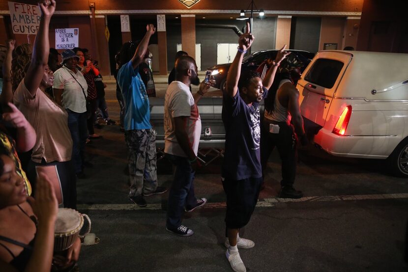 About three dozen demonstrators marched from Dallas Police headquarters to the Dallas Police...