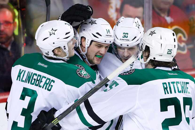 Dallas Stars' Jamie Benn, second from left, celebrates his goal against the Calgary Flames...