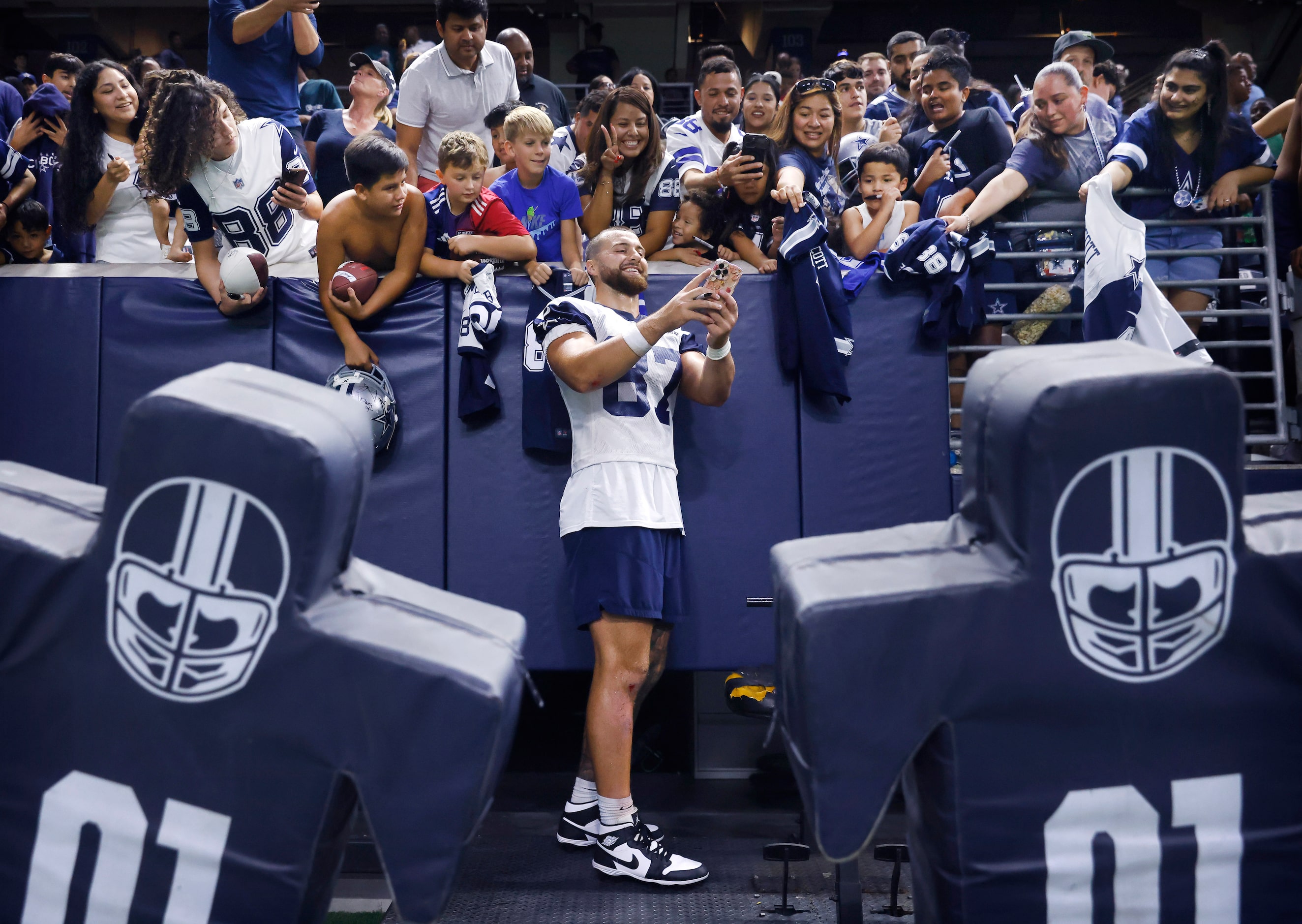 Dallas Cowboys tight end Jake Ferguson (87) takes a selfie for fans following the Season...