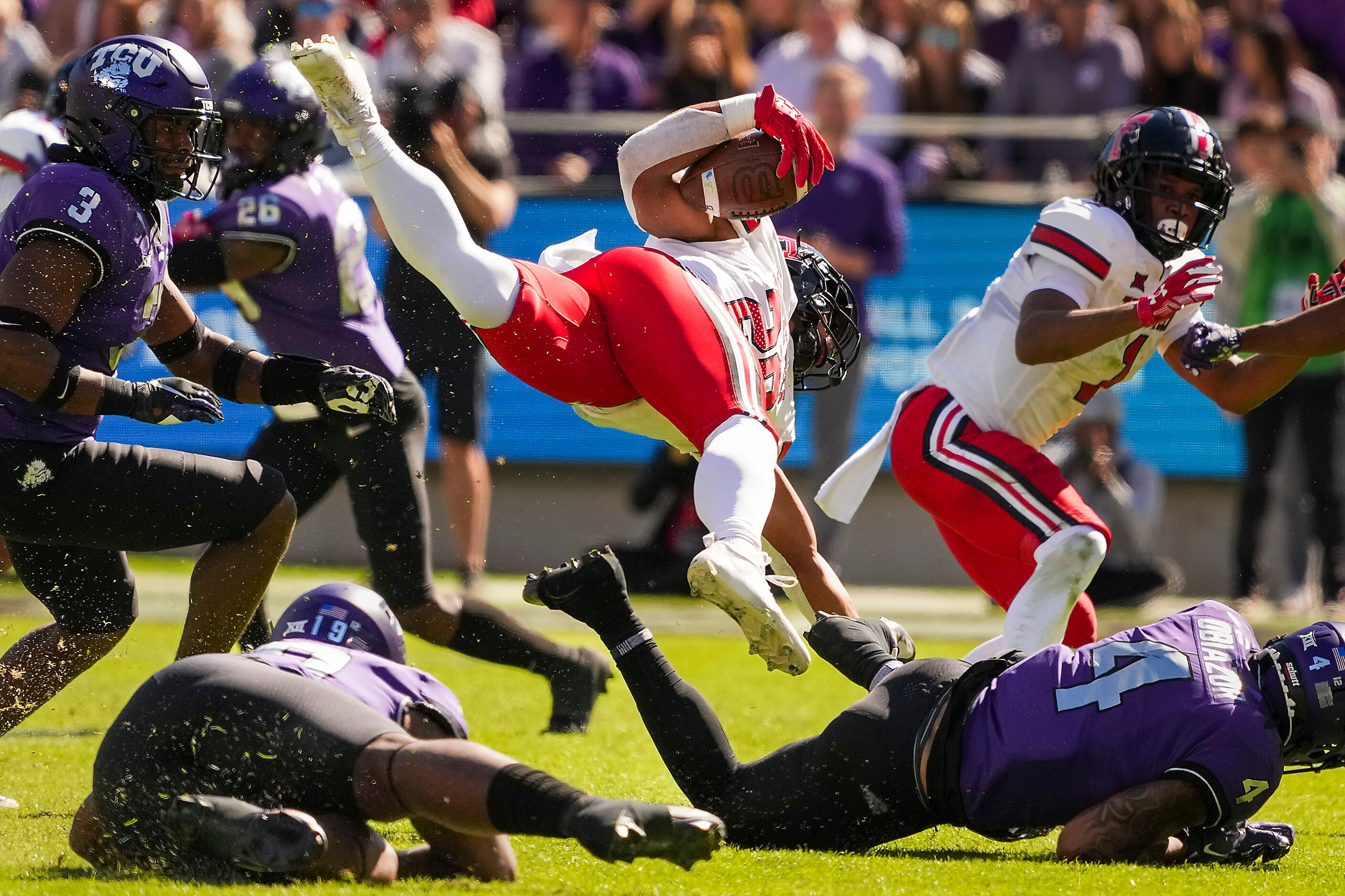 Texas Tech wide receiver Nehemiah Martinez I (20) is knocked off his feet by TCU safety...