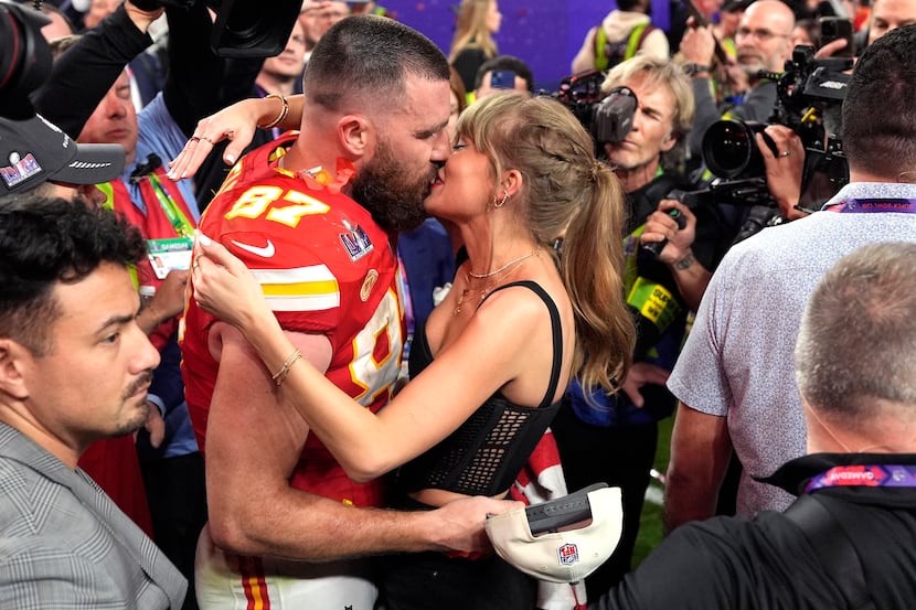 Taylor Swift kisses Kansas City Chiefs tight end Travis Kelce after the NFL Super Bowl 58...