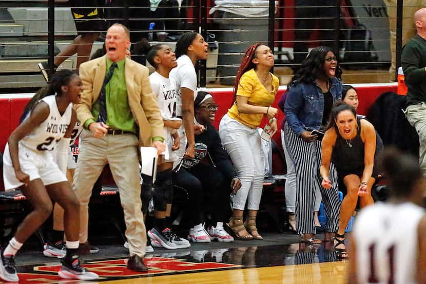 The Timberview High School bench errupts as they pull away during the second half as The...