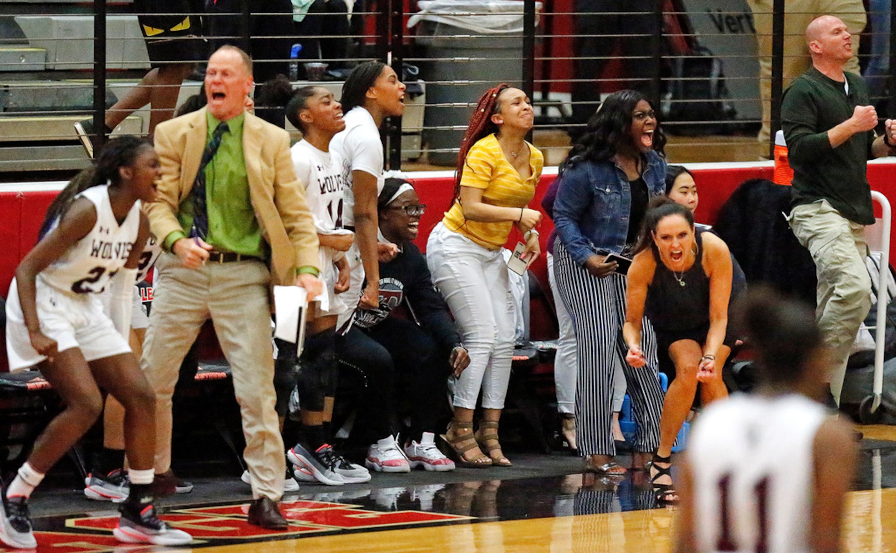 The Timberview High School bench errupts as they pull away during the second half as The...