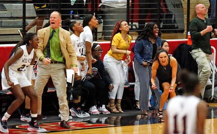 The Timberview High School bench errupts as they pull away during the second half as The...